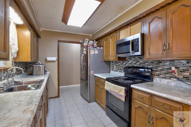 kitchen featuring light tile patterned floors, appliances with stainless steel finishes, brown cabinets, light countertops, and a sink