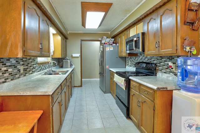 kitchen with stainless steel appliances, brown cabinetry, a sink, and light tile patterned floors