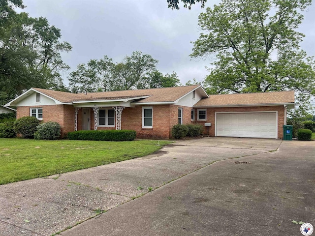 ranch-style house with brick siding, a garage, driveway, and a front yard