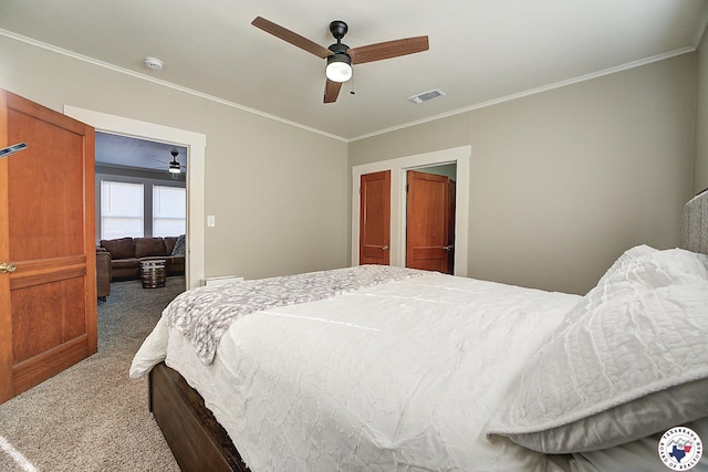 bedroom featuring carpet floors, a ceiling fan, crown molding, and visible vents