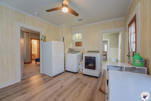 laundry room with ceiling fan, visible vents, light wood-style floors, ornamental molding, and washer and dryer