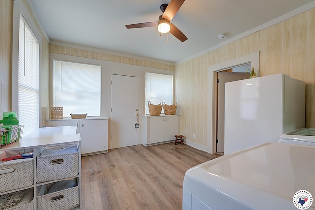 interior space with separate washer and dryer, ceiling fan, ornamental molding, and light wood-style floors