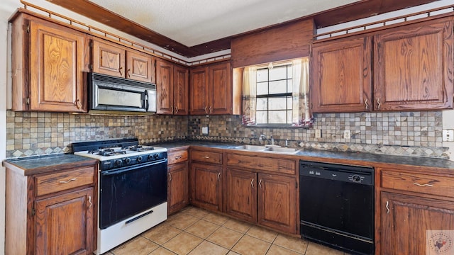kitchen with light tile patterned floors, brown cabinetry, a sink, black appliances, and dark countertops