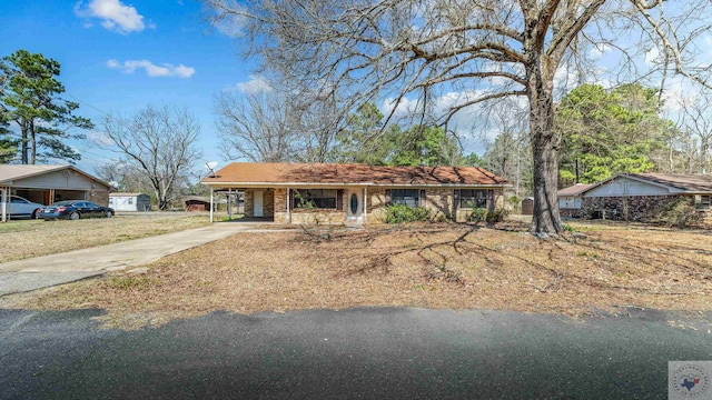 view of front of home featuring an attached carport and concrete driveway