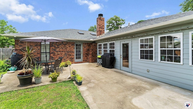 201 Larkspur Ln, Wake Village, TX 75501 - rear view of property featuring a chimney, a patio, and roof with shingles
