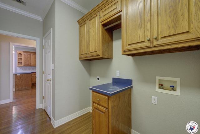 6903 Cherrybark Cir, Texarkana, AR 71854 - laundry room with cabinet space, washer hookup, ornamental molding, wood finished floors, and electric dryer hookup
