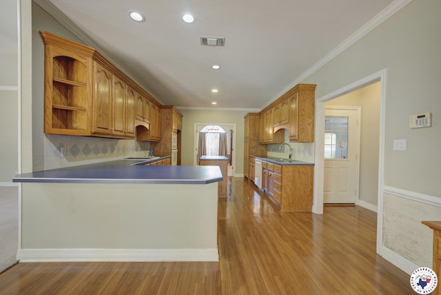 6903 Cherrybark Cir, Texarkana, AR 71854 - kitchen featuring dishwasher, open shelves, backsplash, a peninsula, and wood finished floors