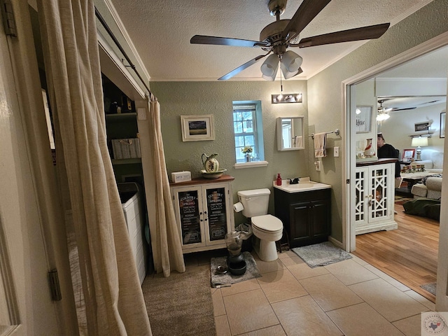 bathroom with ceiling fan, tile patterned floors, vanity, and crown molding