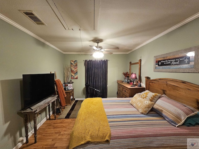 bedroom featuring crown molding, wood-type flooring, a textured ceiling, and ceiling fan