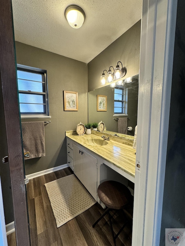 bathroom featuring vanity, hardwood / wood-style flooring, and a textured ceiling