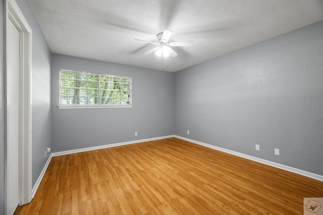 unfurnished room with ceiling fan, hardwood / wood-style floors, and a textured ceiling