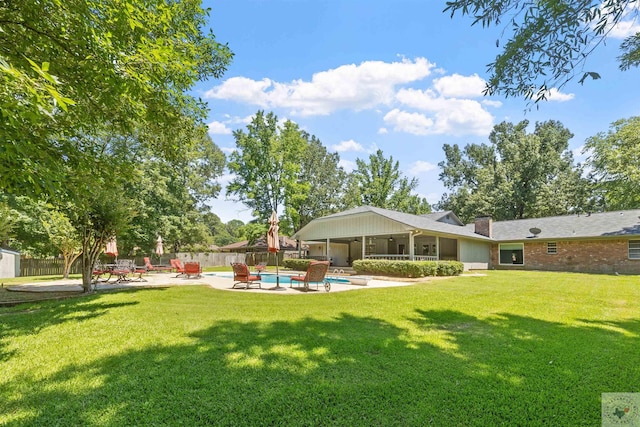 view of yard featuring a fenced in pool and a patio