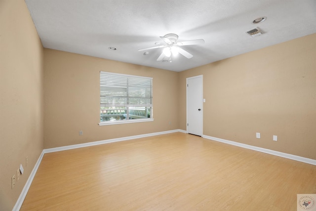 empty room with light hardwood / wood-style floors, a textured ceiling, and ceiling fan