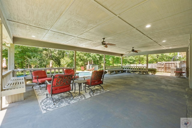 view of patio / terrace featuring ceiling fan and a fenced in pool