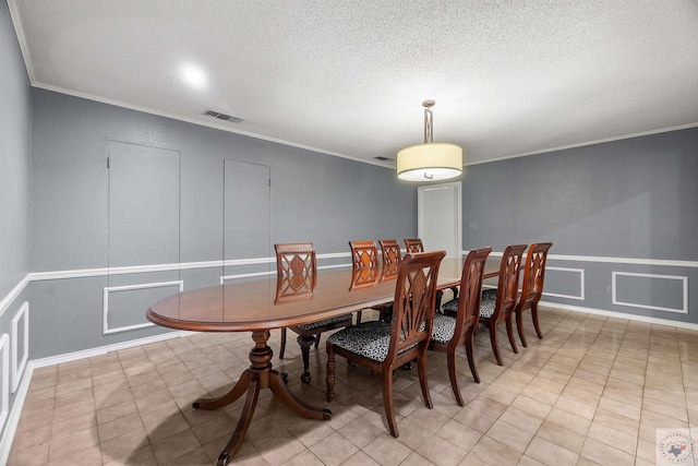 dining space with crown molding and light tile patterned flooring