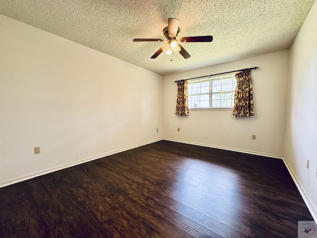 spare room with ceiling fan, dark wood-type flooring, and a textured ceiling