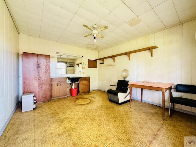 living area with ceiling fan