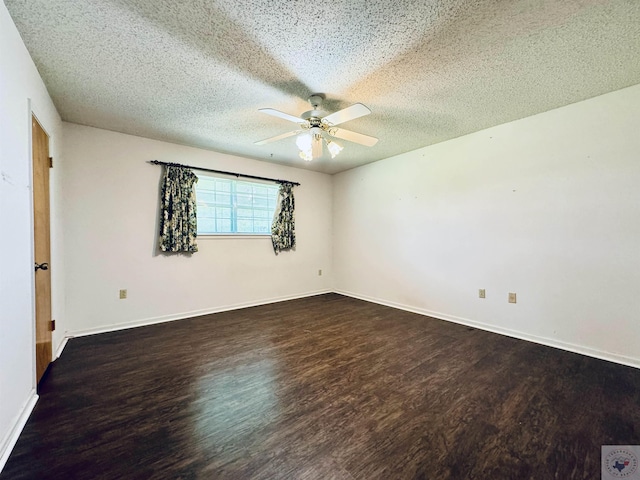 empty room with ceiling fan, a textured ceiling, and dark hardwood / wood-style floors