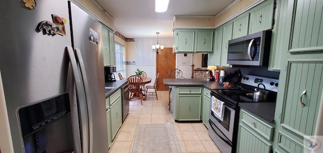 kitchen featuring light tile patterned flooring, green cabinets, hanging light fixtures, and appliances with stainless steel finishes