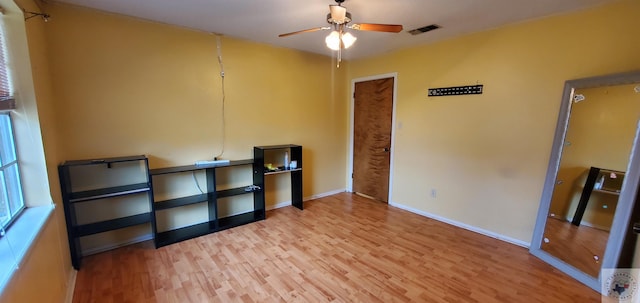 empty room with light hardwood / wood-style flooring and ceiling fan