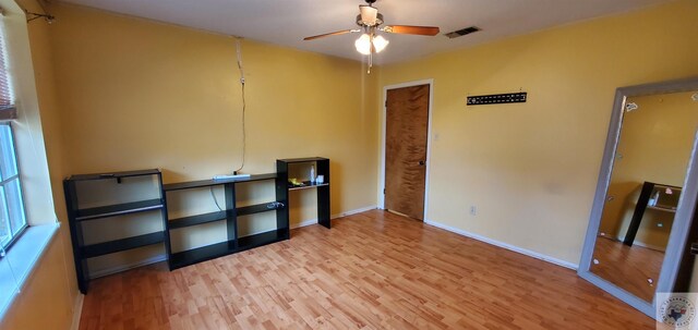 empty room with light hardwood / wood-style flooring and ceiling fan