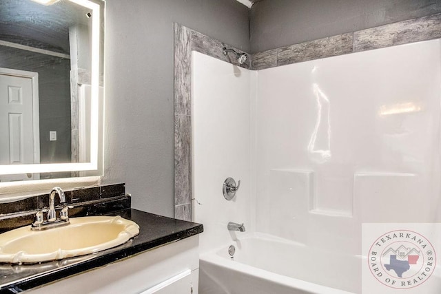 bathroom with vanity and washtub / shower combination