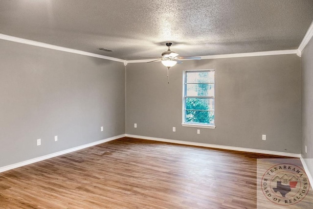 unfurnished room featuring ceiling fan, crown molding, baseboards, and wood finished floors