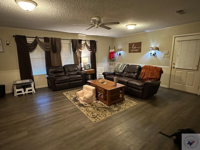 living room with ceiling fan, a textured ceiling, and dark hardwood / wood-style flooring