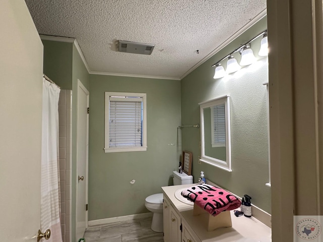 bathroom with a textured ceiling, vanity, toilet, walk in shower, and crown molding