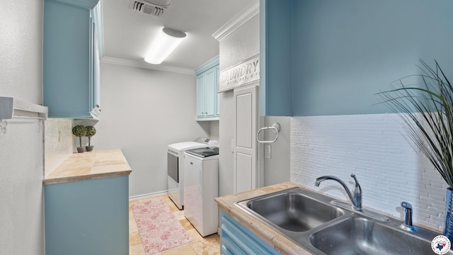 10 High Point Dr, Texarkana, TX 75503 - laundry room featuring cabinet space, washing machine and clothes dryer, ornamental molding, and light tile patterned floors