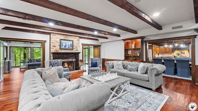 10 High Point Dr, Texarkana, TX 75503 - living area featuring a wainscoted wall, a fireplace, wood-type flooring, plenty of natural light, and beamed ceiling