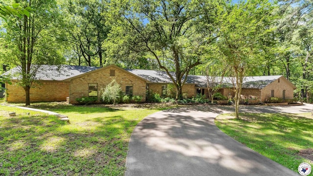 10 High Point Dr, Texarkana, TX 75503 - ranch-style home with brick siding, a front lawn, driveway, and a shingled roof