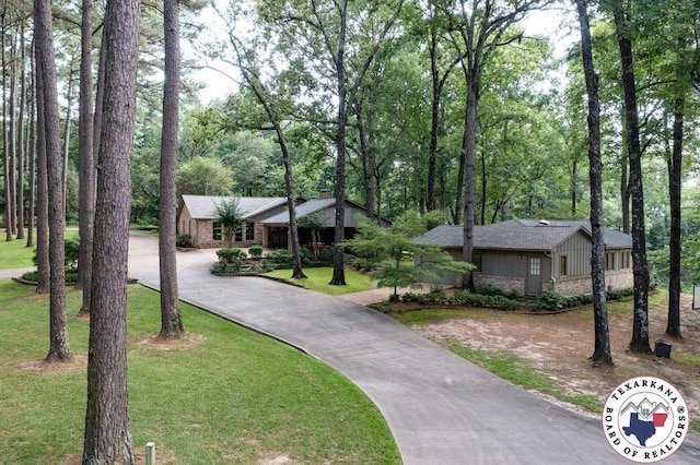 10 High Point Dr, Texarkana, TX 75503 - view of front of house featuring asphalt driveway, a front lawn, and board and batten siding
