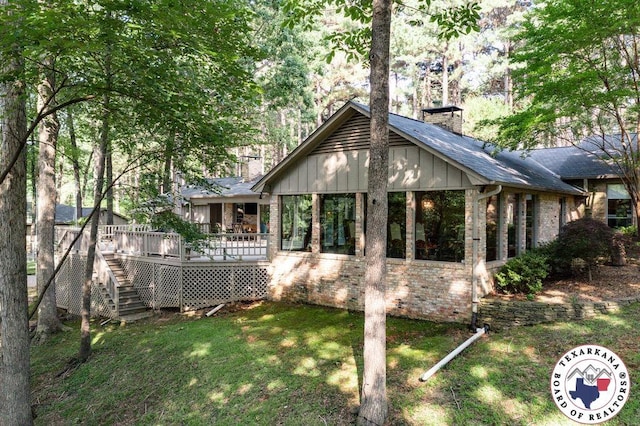 10 High Point Dr, Texarkana, TX 75503 - rear view of house with a chimney, brick siding, stairs, a sunroom, and a wooden deck