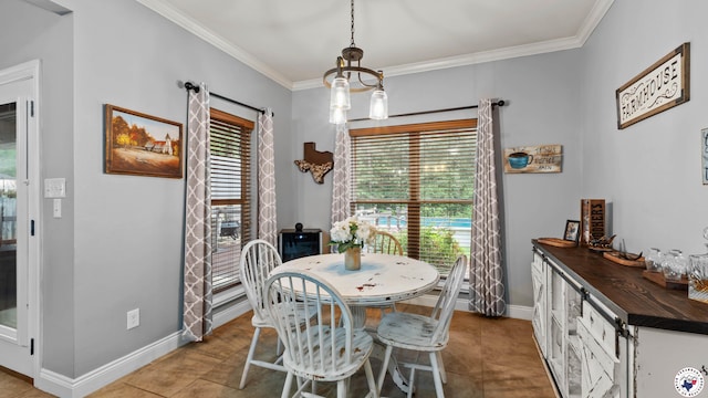 dining space featuring crown molding, baseboards, and a notable chandelier