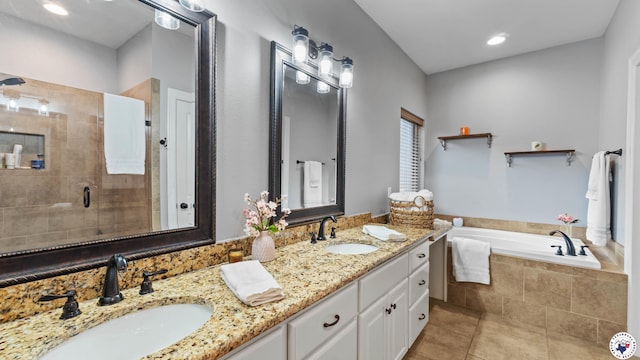 full bathroom featuring a shower stall, a bath, tile patterned floors, and a sink