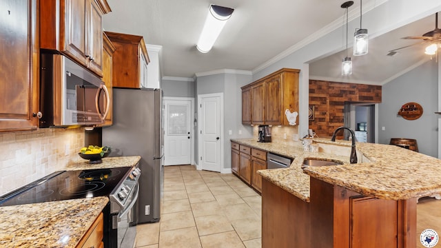 kitchen with a peninsula, backsplash, appliances with stainless steel finishes, and a sink