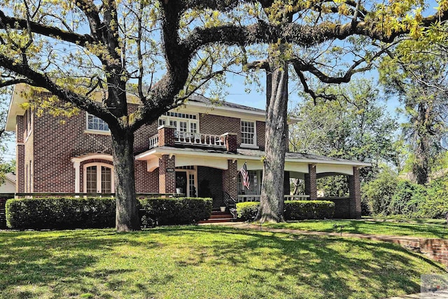 1203 Grand Ave, Texarkana, AR 71854 - view of front of house featuring a balcony, brick siding, and a front yard