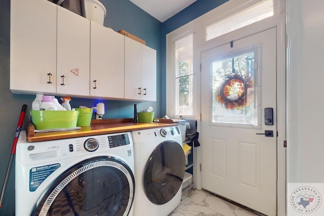 laundry area featuring cabinets and washer and clothes dryer