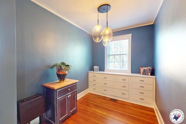 1203 Grand Ave, Texarkana, AR 71854 - interior space featuring baseboards, visible vents, wood finished floors, and crown molding