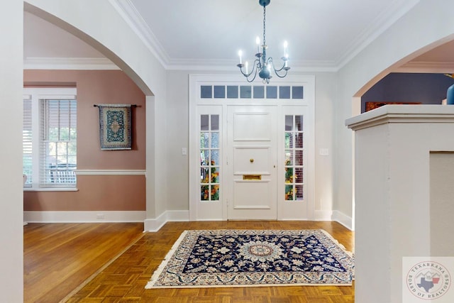 foyer with parquet flooring, a chandelier, and ornamental molding