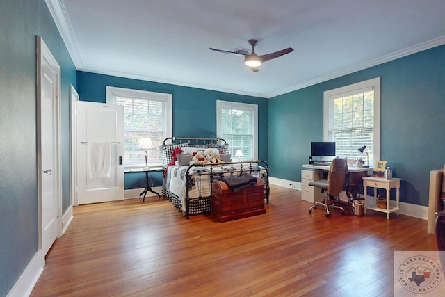 1203 Grand Ave, Texarkana, AR 71854 - bedroom featuring baseboards, crown molding, wood finished floors, and a ceiling fan