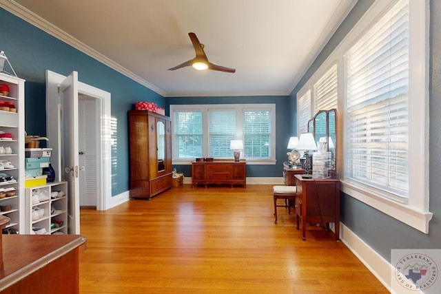 interior space featuring light hardwood / wood-style floors, ornamental molding, and ceiling fan