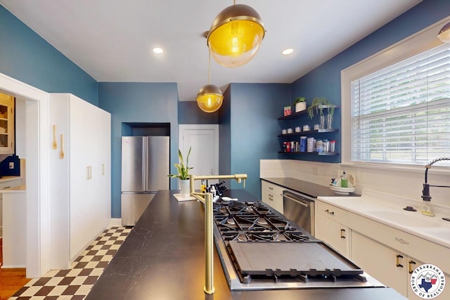 1203 Grand Ave, Texarkana, AR 71854 - kitchen featuring tile patterned floors, a sink, appliances with stainless steel finishes, hanging light fixtures, and recessed lighting