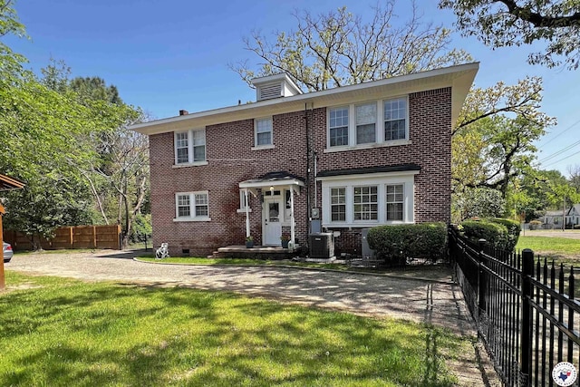 1203 Grand Ave, Texarkana, AR 71854 - view of front of property with central AC, brick siding, fence, and a front lawn