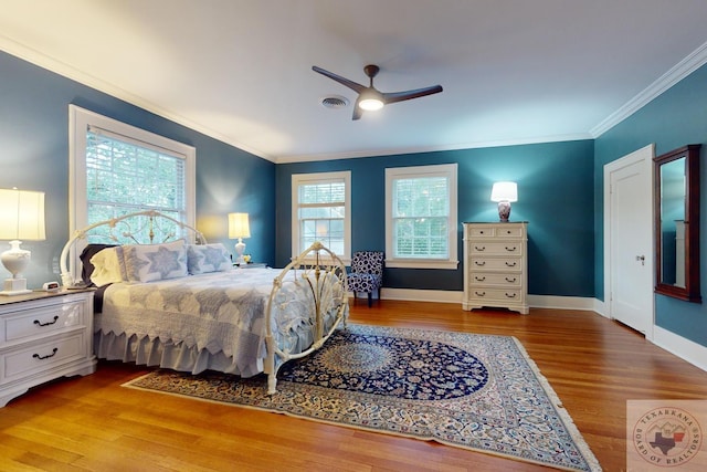 bedroom featuring light wood-type flooring, ceiling fan, and ornamental molding