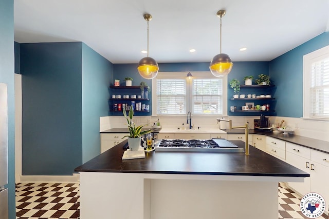 1203 Grand Ave, Texarkana, AR 71854 - kitchen featuring a healthy amount of sunlight, open shelves, a center island, tile patterned floors, and dark countertops