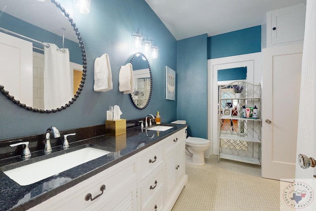 bathroom featuring vanity, toilet, and tile patterned flooring