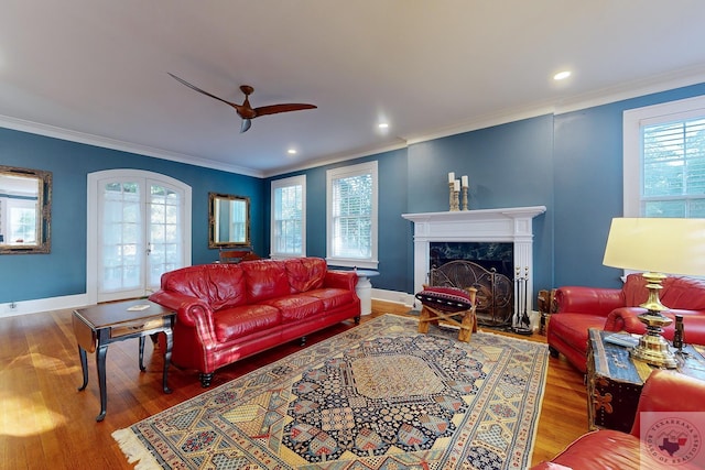 living room with wood-type flooring, crown molding, and french doors