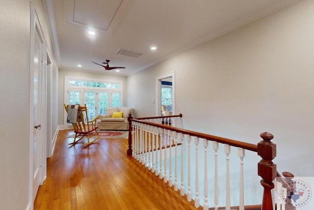 corridor with crown molding and light hardwood / wood-style floors